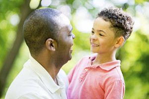 Family portrait of a father and son looking happy